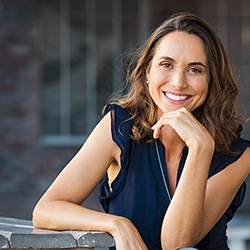 woman smiling after getting cosmetic dentistry in Arlington