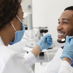 A male patient having a dental checkup and cleaning by his dentist