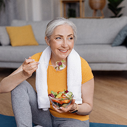 woman eating a salad after doing yoga