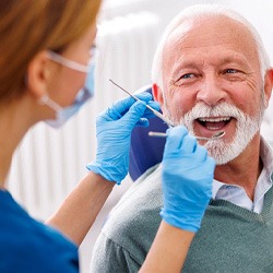 Mature man smiling during dental checkup