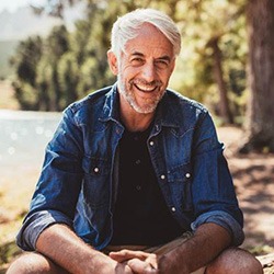 Man enjoying the benefits of dental implants in Arlington outside