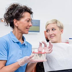 Implant dentist in Arlington explaining treatment to patient