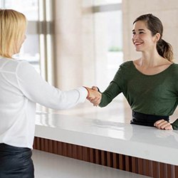 Employee explaining cost of dental implants in Arlington to patient