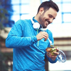 a man enjoying a salad bowl to promote oral health
