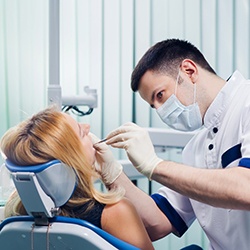 Woman having scaling and root planing treatment.