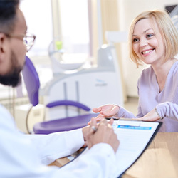 a patient discussing the cost of veneers in Arlington