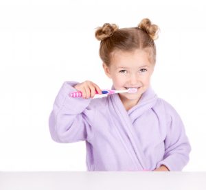 little girl brushing teeth