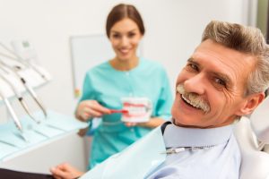 Smiling senior man in dental chair