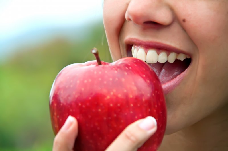 closeup of someone eating an apple
