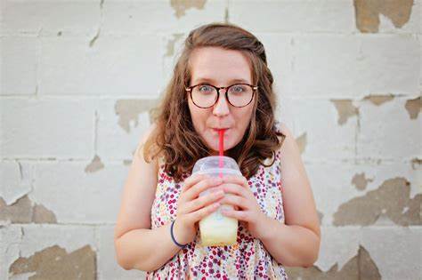 person drinking through a straw